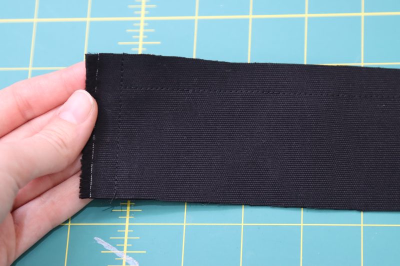 How To Sew Waistband Right Sides Together - Cotton Canvas - Mood Fabrics - Clarkston Carpenter Pants Free Sewing Pattern Tutorial - MDF503 - Mood Fabrics Sewciety Blog - Sew the two short sides and one of the long sides of the waistband pieces.