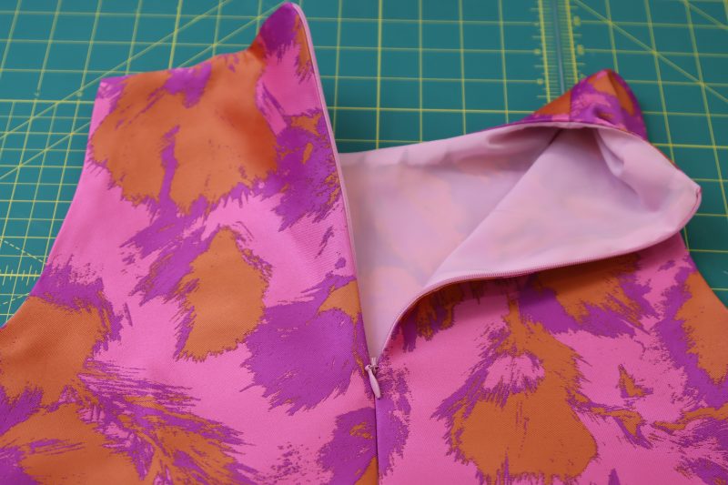 How To Insert Invisible Zipper At Center Back - Invisible Zipper - Mood Fabrics - Chelsea Brocade Set Free Sewing Pattern Tutorial - MDF508 - Mood Fabrics Sewciety Blog - Insert an invisible zipper between the brocade and the lining.