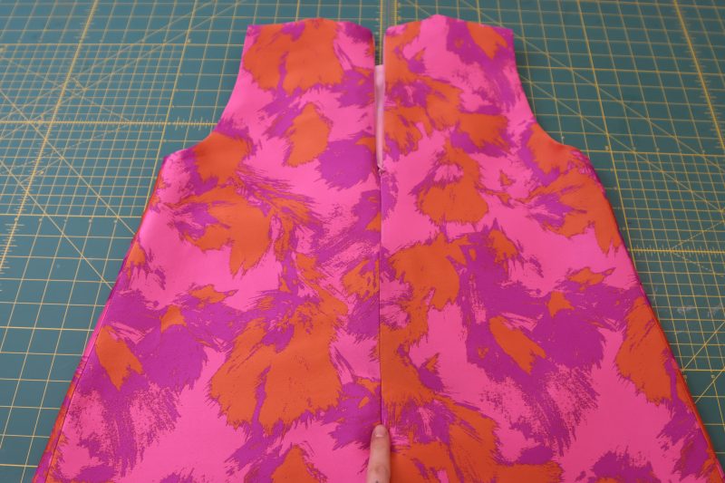 How To Press Center Back Seam Under Zipper - Luxury Polyester Brocade - Mood Fabrics - Chelsea Brocade Set Free Sewing Pattern Tutorial - MDF508 - Mood Fabrics Sewciety Blog - Press the center back seam open and flat.