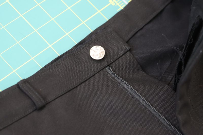 How To Secure Button Cap - Silver Jeans Button - Mood Fabrics - Clarkston Carpenter Pants Free Sewing Pattern Tutorial - MDF503 - Mood Fabrics Sewciety Blog - Secure the button cap with a heavy object.