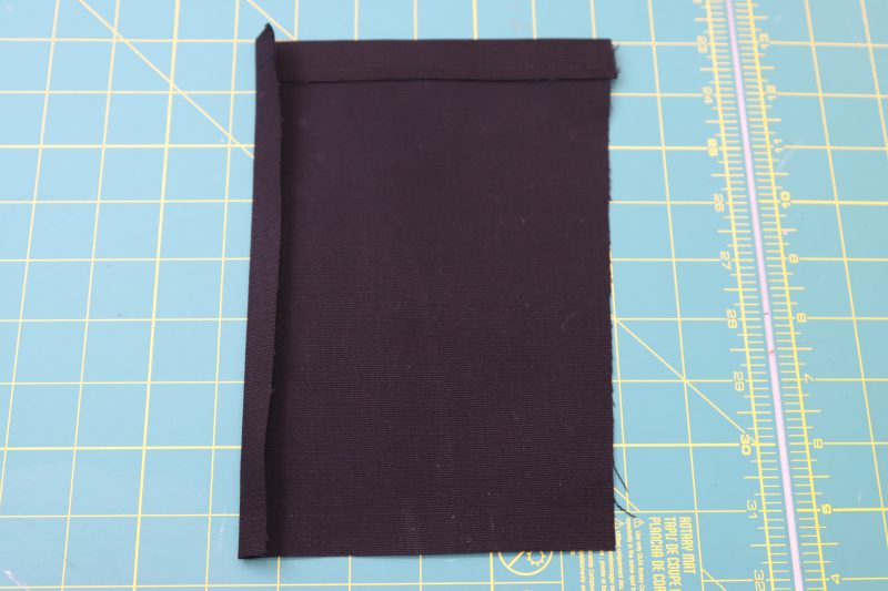 How To Fold Side Pocket Sides - Cotton Canvas - Mood Fabrics - Colfax Carpenter Pants Free Sewing Pattern Tutorial - MDF504 - Mood Fabrics Sewciety Blog - Fold the top and side of the side pocket.