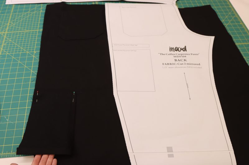 How To Line Up Side Pocket Bottom With Markings - Cotton Canvas - Mood Fabrics - Colfax Carpenter Pants Free Sewing Pattern Tutorial - MDF504 - Mood Fabrics Sewciety Blog - Line up the bottom of the pocket with the bottom of the marking on the pattern, right sides together.