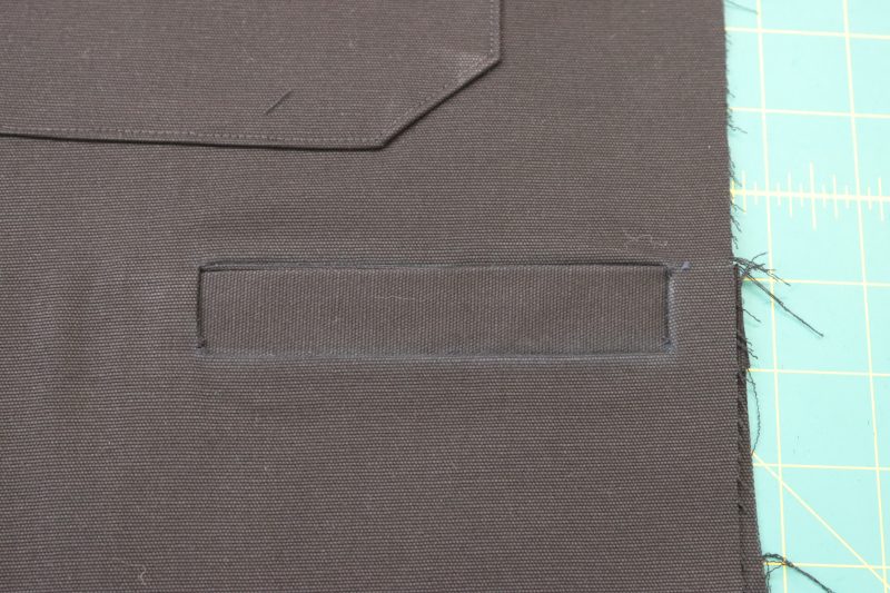 How To Flip Welt Towards Wrong Side - Cotton Canvas - Mood Fabrics - Colfax Carpenter Pants Free Sewing Pattern Tutorial - MDF504 - Mood Fabrics Sewciety Blog - Flip the welt and pocket lining towards the inside of the pants.
