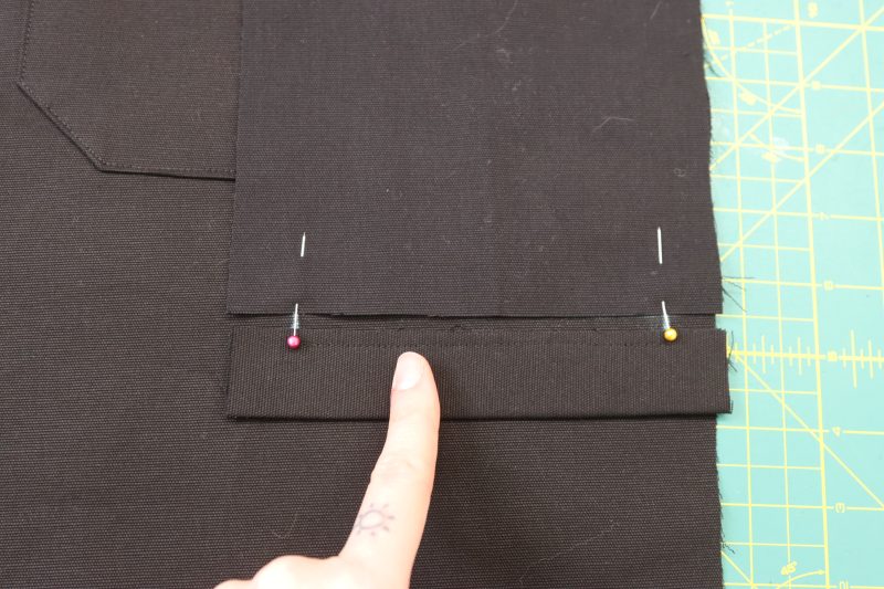 How To Pin Welt Lining To Chalk Lines - Cotton Canvas - Mood Fabrics - Colfax Carpenter Pants Free Sewing Pattern Tutorial - MDF504 - Mood Fabrics Sewciety Blog - Pin the pocket lining to the top chalk line.