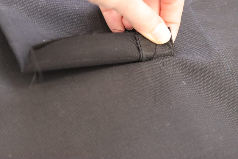 How To Sew Welt Lining Sides - Cotton Canvas - Mood Fabrics - Colfax Carpenter Pants Free Sewing Pattern Tutorial - MDF504 - Mood Fabrics Sewciety Blog - Sew the sides of the pocket lining shut, being sure to catch the triangular side of the welt opening.