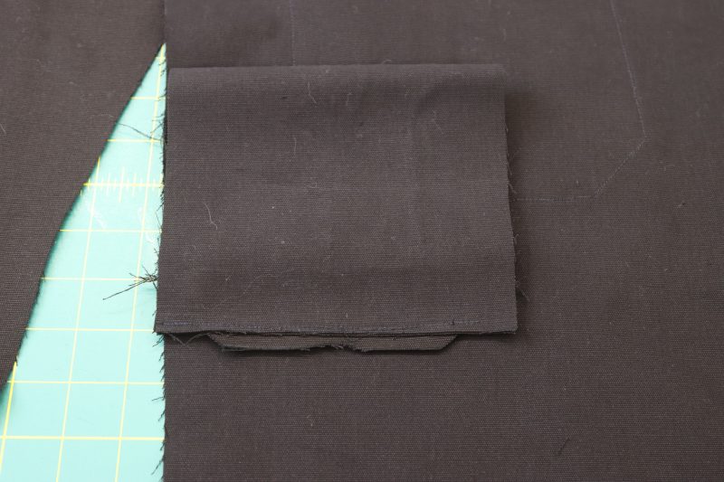 How To Sew Welt Lining To Seam Allowance - Cotton Canvas - Mood Fabrics - Colfax Carpenter Pants Free Sewing Pattern Tutorial - MDF504 - Mood Fabrics Sewciety Blog - Sew the other end of the pocket lining to the seam allowance under the welt.