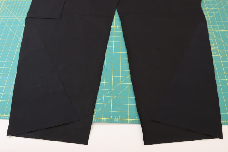 How To Layout Side Bottom - Cotton Canvas - Mood Fabrics - Colfax Carpenter Pants Free Sewing Pattern Tutorial - MDF504 - Mood Fabrics Sewciety Blog - Layout the side bottom triangle pieces.