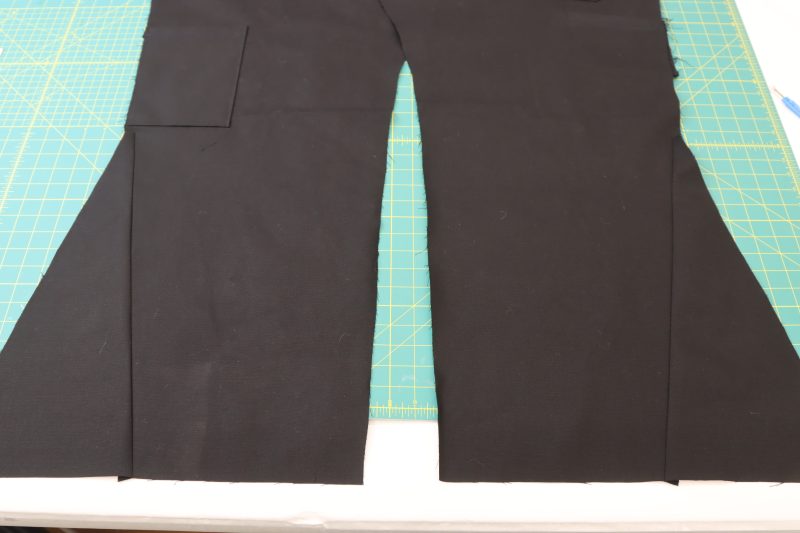 How To Pin Sew Side Bottom - Cotton Canvas - Mood Fabrics - Colfax Carpenter Pants Free Sewing Pattern Tutorial - MDF504 - Mood Fabrics Sewciety Blog - Pin and sew the side bottom triangle pieces to the backs of the pants.