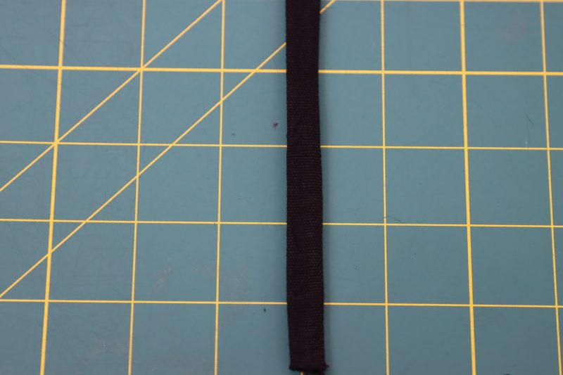 How To Flip Belt Loop Right Sides Out - Cotton Canvas - Mood Fabrics - Colfax Carpenter Pants Free Sewing Pattern Tutorial - MDF504 - Mood Fabrics Sewciety Blog - Flip the belt loop strip right sides out with a loop turner.