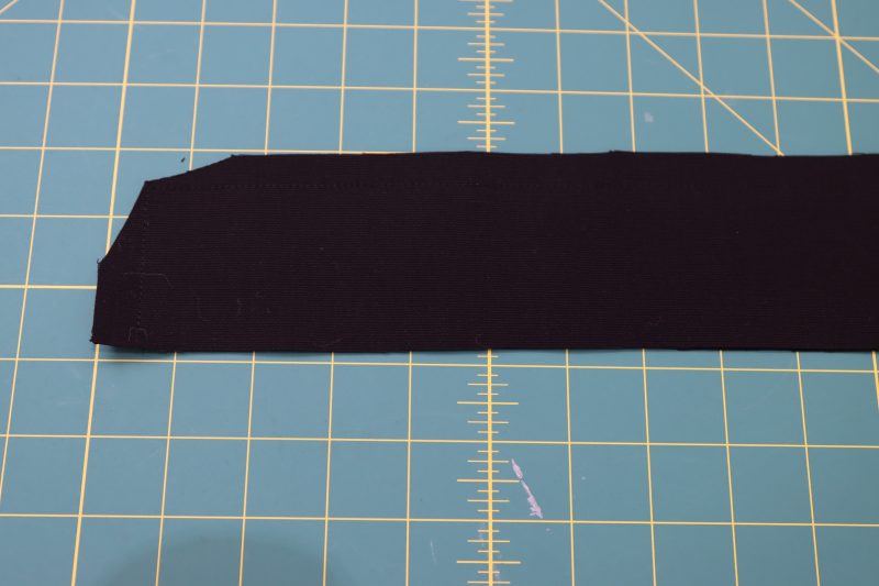 How To Clip Waistband Corners - Cotton Canvas - Mood Fabrics - Colfax Carpenter Pants Free Sewing Pattern Tutorial - MDF504 - Mood Fabrics Sewciety Blog - Clip the corners of the waistband after sewing.