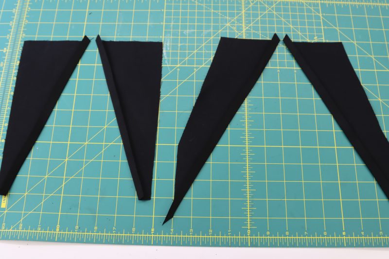 How To Fold Pocket Facings - Cotton Canvas - Mood Fabrics - Colfax Carpenter Pants Free Sewing Pattern Tutorial - MDF504 - Mood Fabrics Sewciety Blog - Fold and press the diagonal edges of the pocket facings.