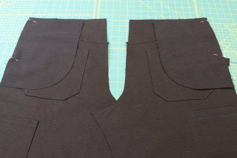 How To Pin Pocket B To Back Pants - Cotton Canvas - Mood Fabrics - Colfax Carpenter Pants Free Sewing Pattern Tutorial - MDF504 - Mood Fabrics Sewciety Blog - Pin the B pockets to the backs of the pants at the side seam.