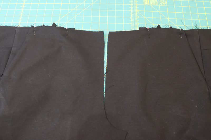 How To Pin Front Pockets To Waistline - Cotton Canvas - Mood Fabrics - Colfax Carpenter Pants Free Sewing Pattern Tutorial - MDF504 - Mood Fabrics Sewciety Blog - Pin the tops of the front pockets to the waistline of the pants.