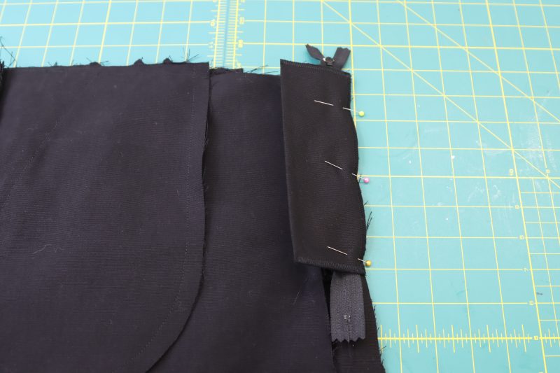 How To Sandwich Zipper Between Fly Shield And Pants - Regular Zipper - Mood Fabrics - Colfax Carpenter Pants Free Sewing Pattern Tutorial - MDF504 - Mood Fabrics Sewciety Blog - Sandwich the other side of the zipper between the right-hand side of the pants and the fly shield.