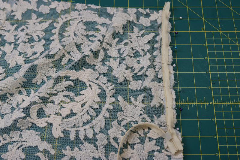 How To Pin Zipper Right Sides Together With Side Front - Invisible Zipper - Mood Fabrics - Taiga Trapeze Skirt Free Sewing Pattern Tutorial - MDF512 - Mood Fabrics Sewciety Blog - Pin one side of the zipper right sides together with the side seam of the front of the skirt.