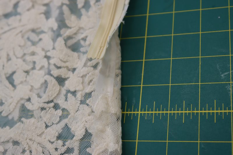 How To Pin Sew Side Seam Under Zipper - Embroidered Lace - Mood Fabrics - Taiga Trapeze Skirt Free Sewing Pattern Tutorial - MDF512 - Mood Fabrics Sewciety Blog - Pin and sew the open side seam under the zipper.