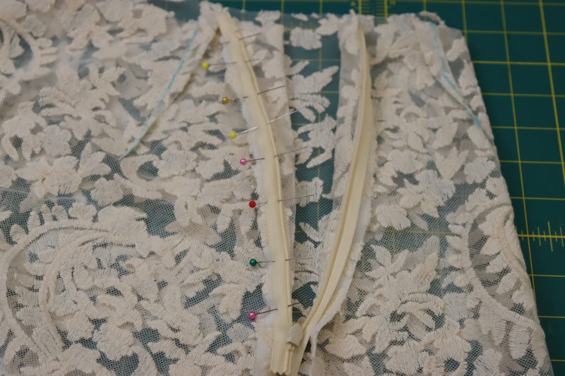 How To Pin Zipper Right Sides Together With Side Back - Invisible Zipper - Mood Fabrics - Taiga Trapeze Skirt Free Sewing Pattern Tutorial - MDF512 - Mood Fabrics Sewciety Blog - Pin the other side of the zipper tape right sides together with the back side seam of the skirt.