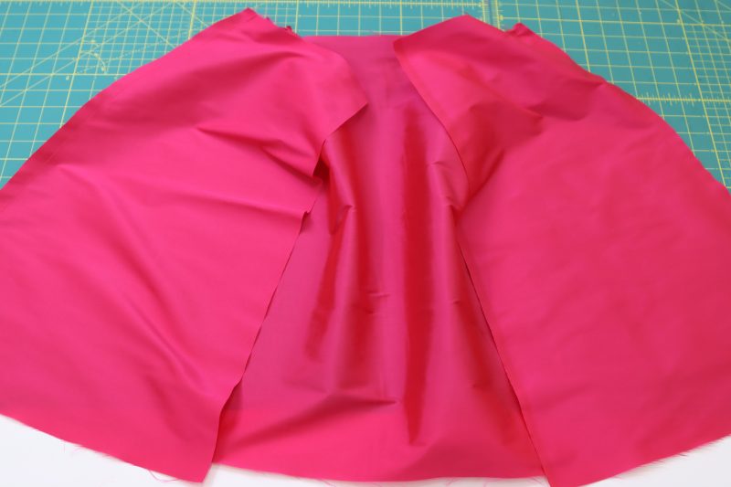 How To Pin Sew Outer Skirt Side Seams - Polyester Taffeta - Mood Fabrics - Biella Fit and Flare Dress Free Sewing Pattern Tutorial - MDF514 - Mood Fabrics Sewciety Blog - Pin and sew the outer skirt side seams.