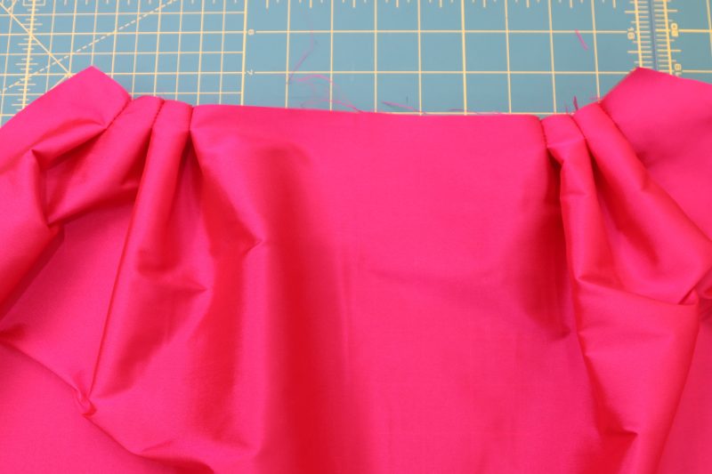 How To Sew Outer Skirt Pleats - Polyester Taffeta - Mood Fabrics - Biella Fit and Flare Dress Free Sewing Pattern Tutorial - MDF514 - Mood Fabrics Sewciety Blog - Sew each of the 6 pleats ½ inch down from the waistline.