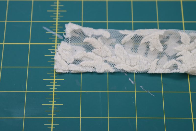 How To Sew Short Ends Of Waistband - Embroidered Lace - Mood Fabrics - Taiga Trapeze Skirt Free Sewing Pattern Tutorial - MDF512 - Mood Fabrics Sewciety Blog - Sew the short ends of the waistband in half then clip the corner.
