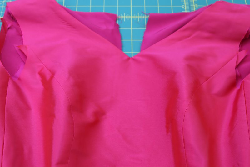 How To Flip Dress Right Sides Out - Polyester Taffeta - Mood Fabrics - Biella Fit and Flare Dress Free Sewing Pattern Tutorial - MDF514 - Mood Fabrics Sewciety Blog - Flip the dresses right sides out, hiding the seam allowance at the neckline.