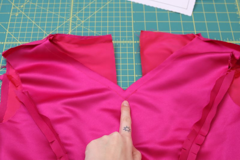 How To Sew Necklines Right Sides Together - Polyester Taffeta - Mood Fabrics - Biella Fit and Flare Dress Free Sewing Pattern Tutorial - MDF514 - Mood Fabrics Sewciety Blog - Sew the necklines of the two dresses together.