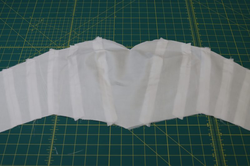 How To Press Interfacing Onto Lining Bodice - Fusible Interfacing - Mood Fabrics - Selenite V Waist Ballgown Free Sewing Pattern Tutorial - MDF515 - Mood Fabrics Sewciety Blog - Hold the seam allowances open for the interfacing and press the interfacing bodice to the lining bodice.