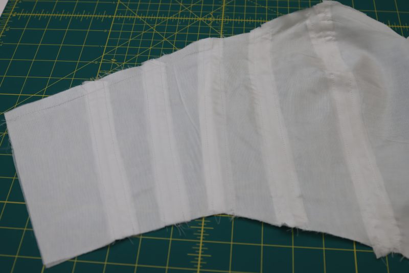 How To Sew Stitches To Create Boning Channels - Gutermann Sew All Thread - Mood Fabrics - Selenite V Waist Ballgown Free Sewing Pattern Tutorial - MDF515 - Mood Fabrics Sewciety Blog - Sew straight stitches on either side of each seam on the bodice.