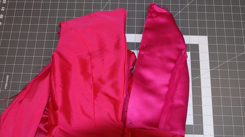 How To Pin Opposite Side Of Zipper Tape - Invisible Zipper - Mood Fabrics - Biella Fit and Flare Dress Free Sewing Pattern Tutorial - MDF514 - Mood Fabrics Sewciety Blog - Pin the opposite side of the zipper right sides together with the opposite side of the center back of the dress.