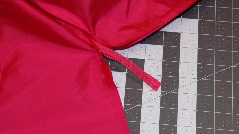 How To Pin Sew Center Back Seam Under Zipper - Polyester Taffeta - Mood Fabrics - Biella Fit and Flare Dress Free Sewing Pattern Tutorial - MDF514 - Mood Fabrics Sewciety Blog - Pin and sew the lining and main fabric at the center back seam under the zipper to close the back of the dress.