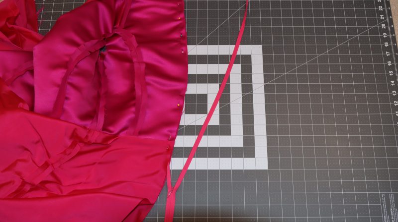 How To Pin Zipper Between Lining And Shell - Invisible Zipper - Mood Fabrics - Biella Fit and Flare Dress Free Sewing Pattern Tutorial - MDF514 - Mood Fabrics Sewciety Blog - Pin the zipper right sides together between the main dress and the lining dress at the center back seam.