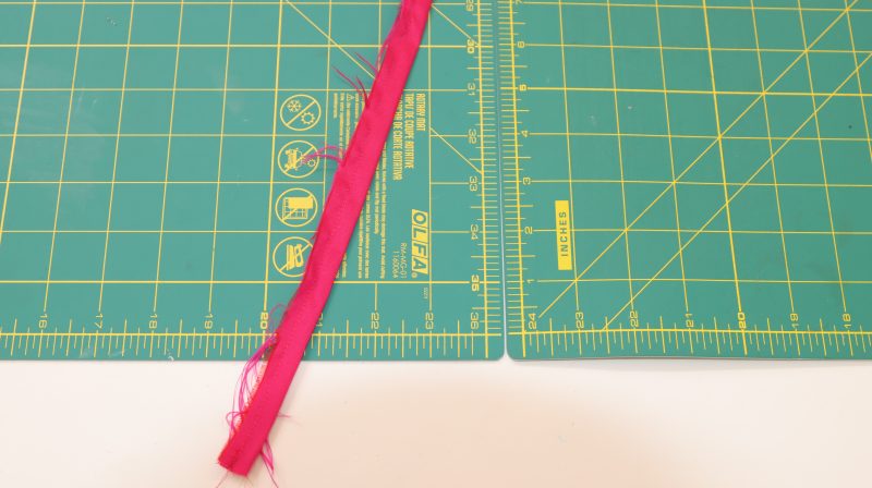 How To Fold Strips Right Sides Together - Polyester Taffeta - Mood Fabrics - Biella Fit and Flare Dress Free Sewing Pattern Tutorial - MDF514 - Mood Fabrics Sewciety Blog - Fold the strips right sides together and sew it into a closed tube.