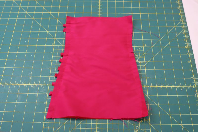 How To Sew Cuffs Right Sides Together - Polyester Taffeta - Mood Fabrics - Biella Fit and Flare Dress Free Sewing Pattern Tutorial - MDF514 - Mood Fabrics Sewciety Blog - Sew the cuff pieces right sides together.