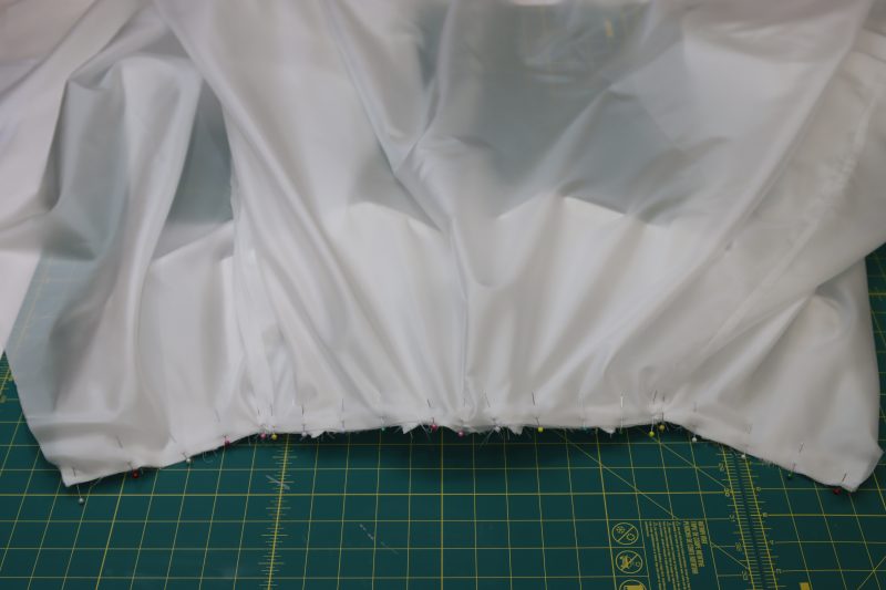 How To Pin Lining Skirt To Lining Bodice Waistline - Polyester Lining - Mood Fabrics - Selenite V Waist Ballgown Free Sewing Pattern Tutorial - MDF515 - Mood Fabrics Sewciety Blog - Pin the lining skirt to the lining bodice.