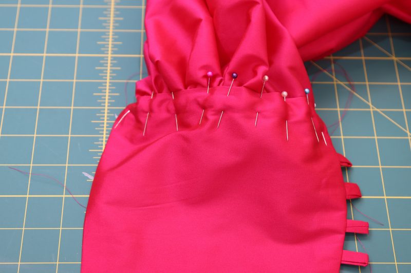 How To Sandwich Gathered Sleeve Into Cuff Opening - Polyester Taffeta - Mood Fabrics - Biella Fit and Flare Dress Free Sewing Pattern Tutorial - MDF514 - Mood Fabrics Sewciety Blog - Sandwich the gathered sleeve into the cuff opening.