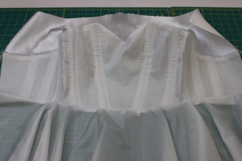 How To Sew Lining Skirt To Lining Bodice Waistline - Polyester Lining - Mood Fabrics - Selenite V Waist Ballgown Free Sewing Pattern Tutorial - MDF515 - Mood Fabrics Sewciety Blog - Sew the lining skirt and lining bodice together at the waistline.