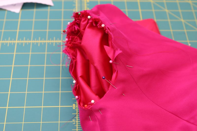 How To Pin Sleeve Cap Into Armscye - Polyester Taffeta - Mood Fabrics - Biella Fit and Flare Dress Free Sewing Pattern Tutorial - MDF514 - Mood Fabrics Sewciety Blog - Pin the gathered sleeve caps to the lining and main fabric armscyes.
