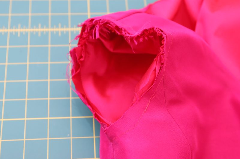 How To Sew Sleeve Cap Into Armscye - Polyester Taffeta - Mood Fabrics - Biella Fit and Flare Dress Free Sewing Pattern Tutorial - MDF514 - Mood Fabrics Sewciety Blog - Sew the sleeves in place at the armscyes.