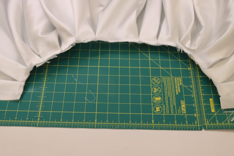 How To Stay Stitch Pleats To Hold Them In Place - Gutermann Sew All Thread - Mood Fabrics - Selenite V Waist Ballgown Free Sewing Pattern Tutorial - MDF515 - Mood Fabrics Sewciety Blog - Stay stitch the box pleats with ¼ inch seam allowance.