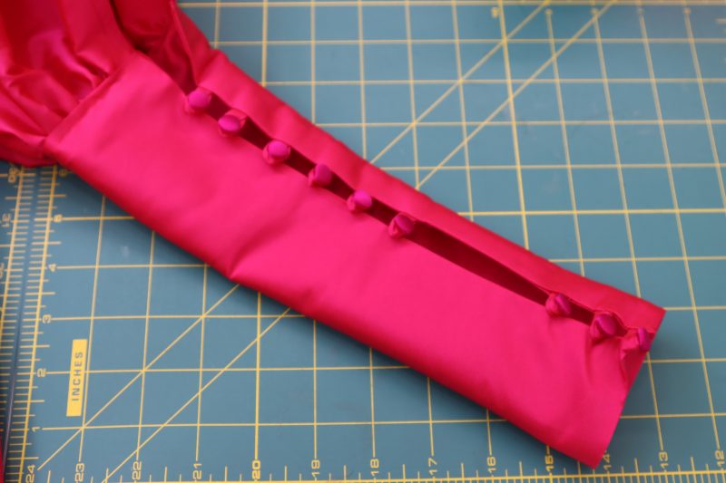How To Sew Satin Buttons By Hand - Satin Covered Buttons - Mood Fabrics - Biella Fit and Flare Dress Free Sewing Pattern Tutorial - MDF514 - Mood Fabrics Sewciety Blog - Hand sew buttons opposite to the button loops.