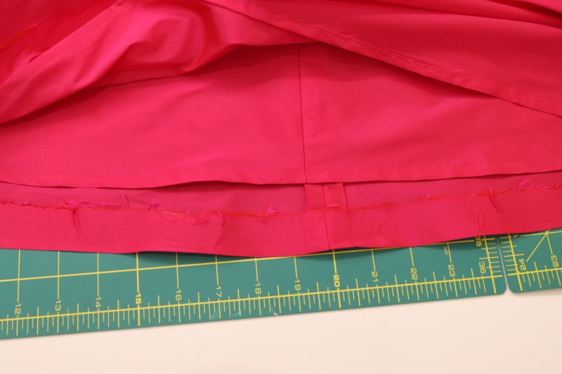 How To Hem Skirt Lining And Main Skirt - Polyester Taffeta - Mood Fabrics - Biella Fit and Flare Dress Free Sewing Pattern Tutorial - MDF514 - Mood Fabrics Sewciety Blog - Hem the lining and main fabric skirt.