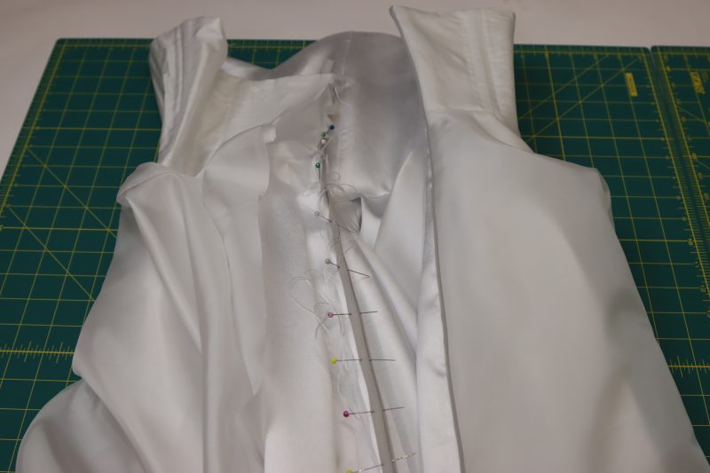 How To Pin Zipper To Opposite Side Of Back Seam - Invisible Zipper - Mood Fabrics - Selenite V Waist Ballgown Free Sewing Pattern Tutorial - MDF515 - Mood Fabrics Sewciety Blog - Pin the other side of the zipper to the opposite side of the center back of the dress.