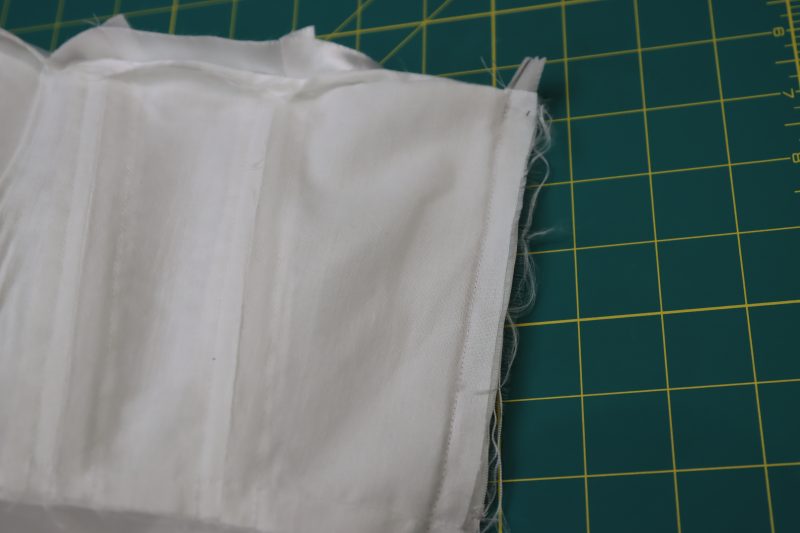 How To Sandwich Zipper Between Shell And Lining And Sew - Invisible Zipper - Mood Fabrics - Selenite V Waist Ballgown Free Sewing Pattern Tutorial - MDF515 - Mood Fabrics Sewciety Blog - Sandwich the zipper between the shell and the lining and sew.