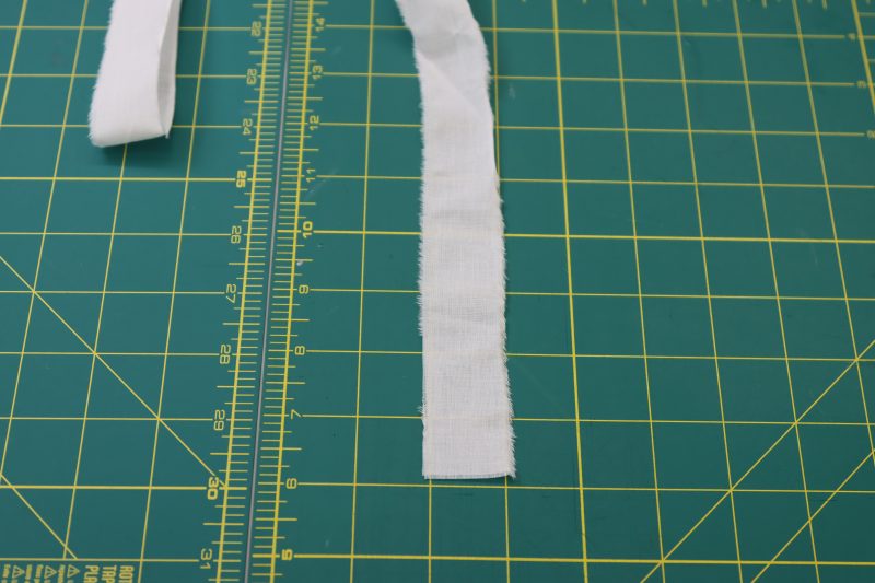 How To Cut Lacing Strips To Length And Width - Cotton Voile - Mood Fabrics - Selenite V Waist Ballgown Free Sewing Pattern Tutorial - MDF515 - Mood Fabrics Sewciety Blog - Cut strips of fabric that are 1 inch wide and 60 inches long.