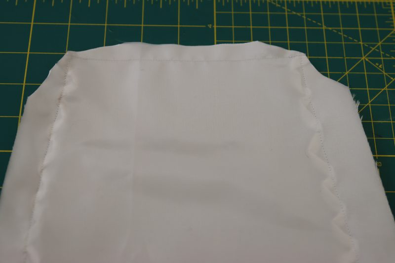 How To Clip Corners And Reduce Bulk On Cuff - Polyester Mikado - Mood Fabrics - Selenite V Waist Ballgown Free Sewing Pattern Tutorial - MDF515 - Mood Fabrics Sewciety Blog - Clip the corners of the sleeve cuff.