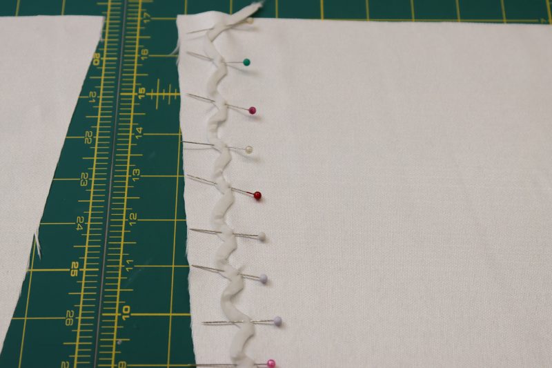 How To Pin Lacing Strip In Zigzag For Cuff Loops - Cotton Voile - Mood Fabrics - Selenite V Waist Ballgown Free Sewing Pattern Tutorial - MDF515 - Mood Fabrics Sewciety Blog - Pin the strip to the sleeve cuff in a zigzag pattern.