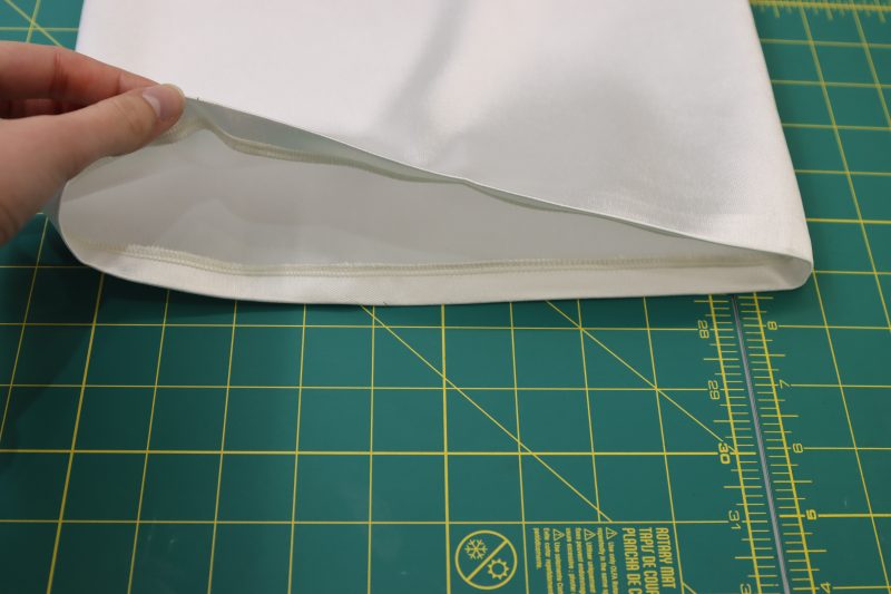 How To Fold Top Edge Of Sleeve To Create Casing - Polyester Mikado - Mood Fabrics - Selenite V Waist Ballgown Free Sewing Pattern Tutorial - MDF515 - Mood Fabrics Sewciety Blog - Press a ½ inch fold into the top edge of the sleeve.