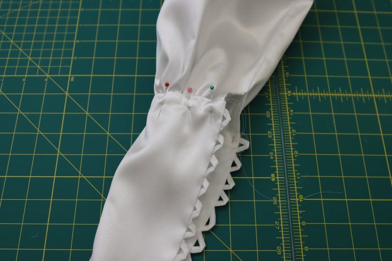 How To Pin Sew Gathered Sleeve Into Cuff - Polyester Mikado - Mood Fabrics - Selenite V Waist Ballgown Free Sewing Pattern Tutorial - MDF515 - Mood Fabrics Sewciety Blog - Pin and sew the gathered sleeve into the cuff.