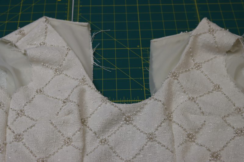 How To Understitch Lining To Seam Allowance Then Flip Dress Right Sides Out - Stretch Polyester Twill Lining - Mood Fabrics - Deauville Cocktail Dress Free Sewing Pattern Tutorial - MDF517 - Mood Fabrics Sewciety Blog - Understitch the lining to the seam allowance, then flip the dress right sides out.