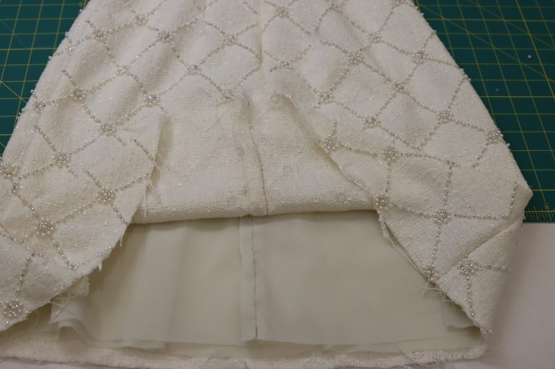 How To Sew Lining And Shell Closed At Center Back Seam Under Zipper - Beaded Tweed - Mood Fabrics - Deauville Cocktail Dress Free Sewing Pattern Tutorial - MDF517 - Mood Fabrics Sewciety Blog - Separately sew the lining and the shell closed at the center back seam under the zipper.
